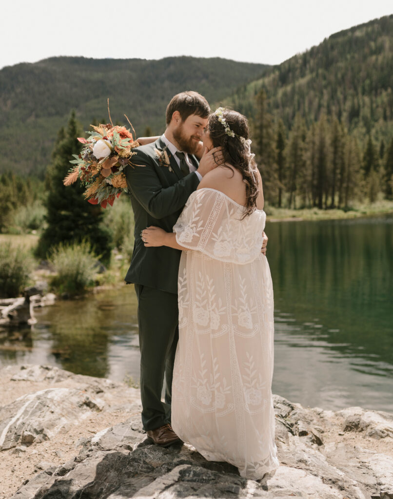 A bride and groom kiss after saying their vows at their elopement at Officer's Gulch near Frisco, Colorado 