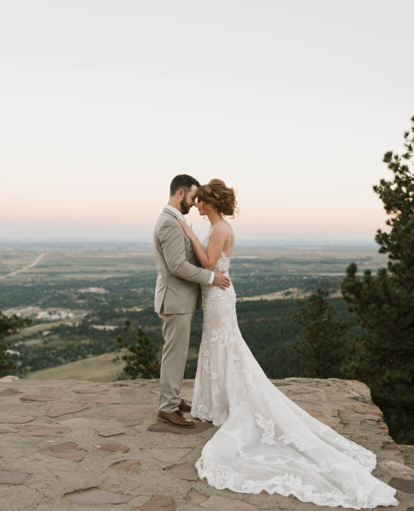 A bride and groom kisses after saying their vows at their intimate wedding ceremony at Sunrise Amphitheater near Boulder, Colorado 