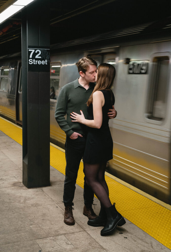 Playful image capturing the couple's connection as they share a moment in an NYC subway station, showcasing the urban charm and spontaneity of their engagement session in busy New York City. 