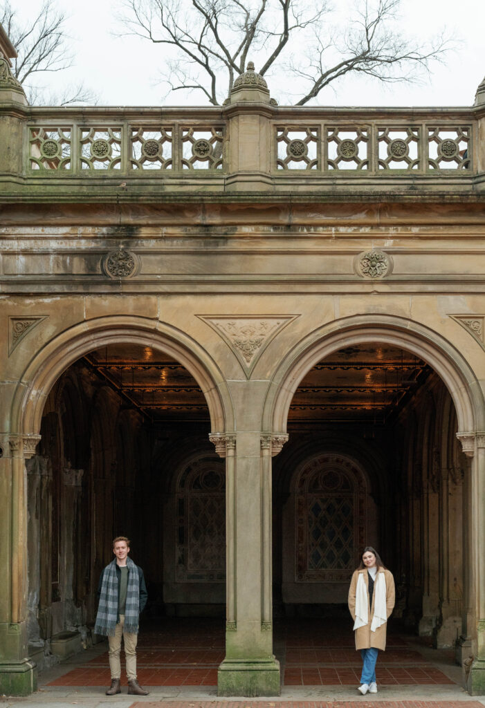 A couple wandering around Bethesda Terrace in Central Park together. Discover candid engagement photos in New York City. 