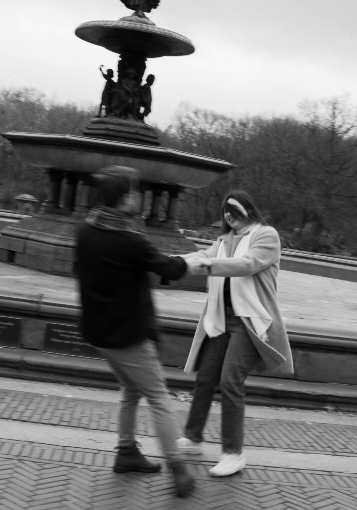 A couple wandering around Central Park together at Bethesda Fountain. Discover candid engagement photos in New York City. 