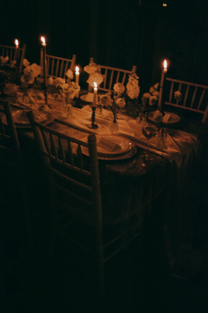 a candle lit wedding table scape captured on film by a new york city wedding photographer 