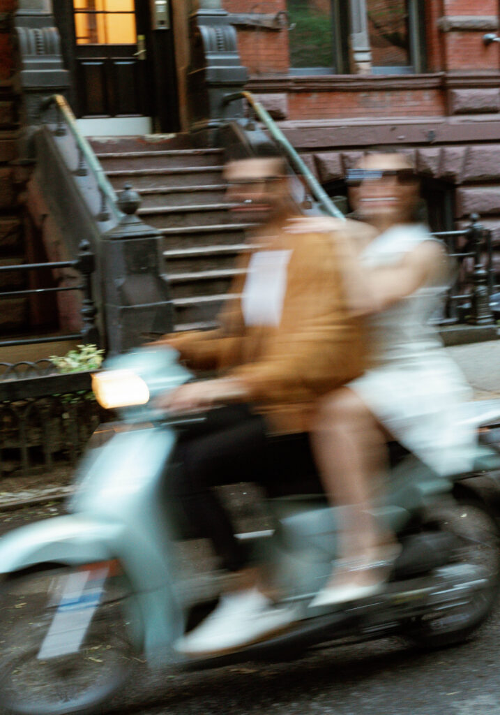 Stylish couple riding a scooter in the West Village for their New York City engagement session. Discover documentary engagement photography in New York City. 