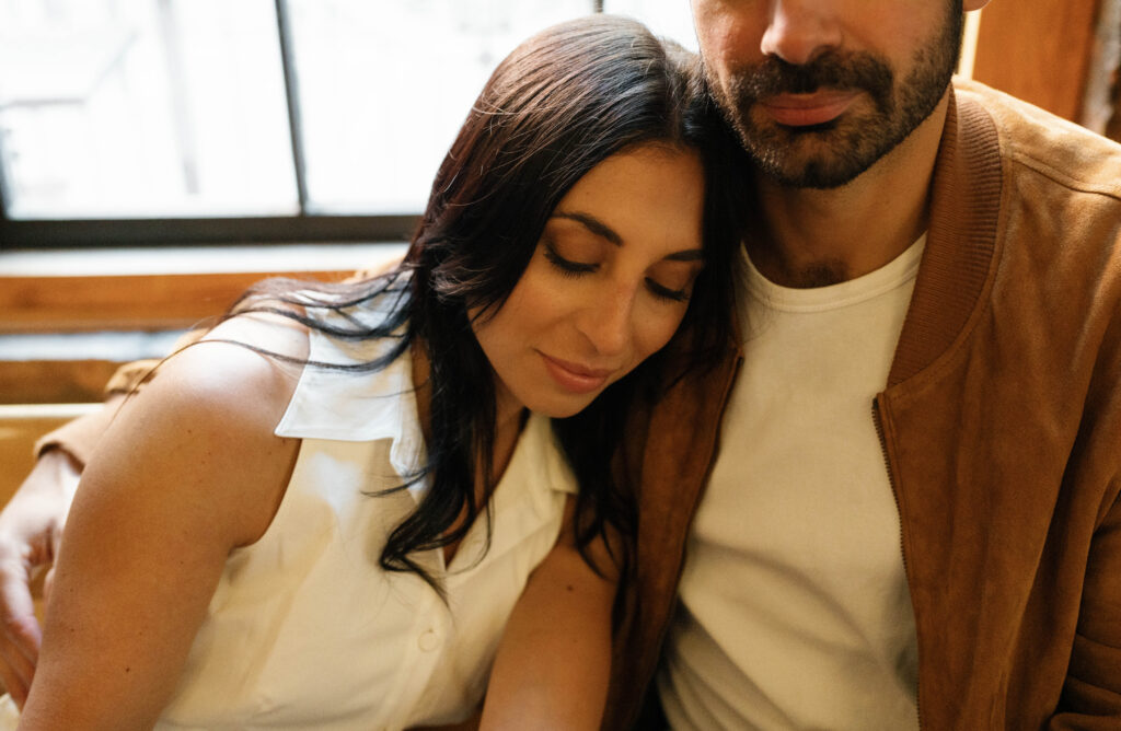 Candid moment of engaged couple at a cozy West Village coffee shop in NYC. Discover documentary and intimate New York City engagement photos. 