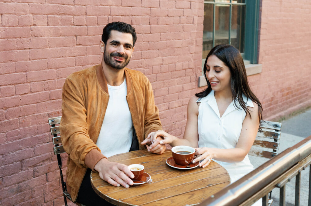 Candid moment of engaged couple at a cozy West Village coffee shop in NYC. Discover documentary and editorial New York City engagement photos. 