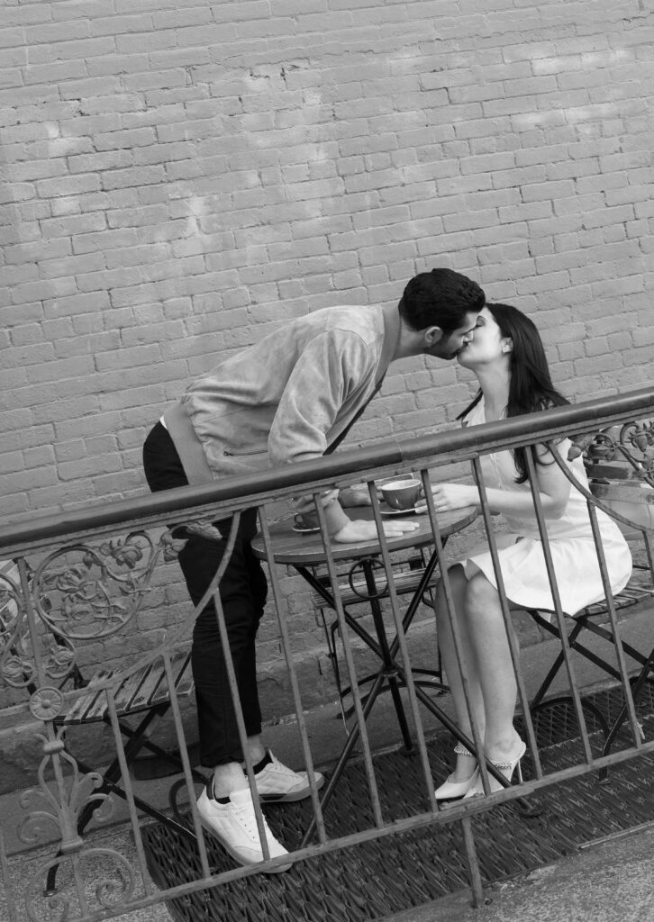 Candid moment of engaged couple at a cozy West Village coffee shop in NYC. Discover documentary and editorial New York City engagement photos. 