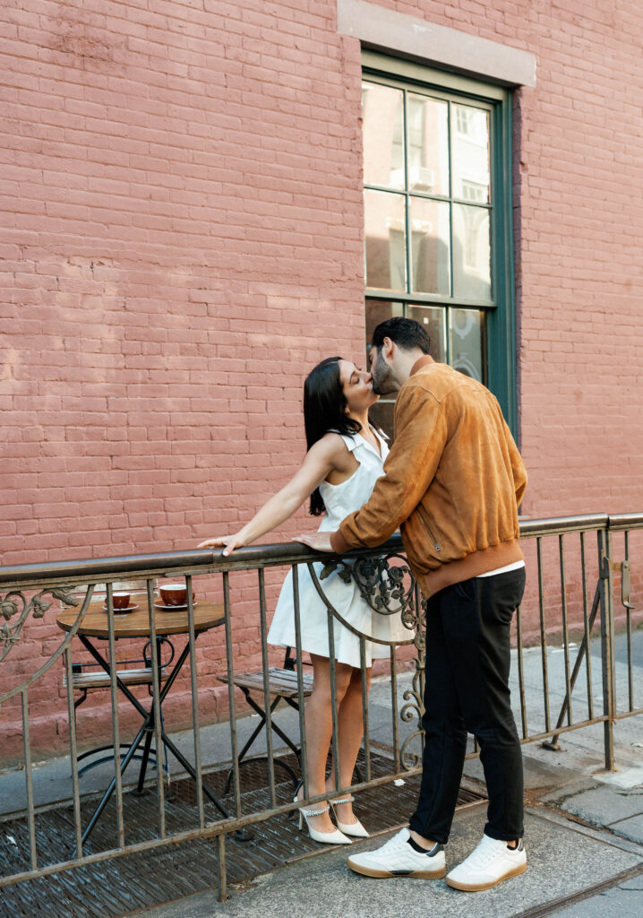 Candid moment of engaged couple at a cozy West Village coffee shop in NYC. Discover documentary and timeless New York City engagement photos. 