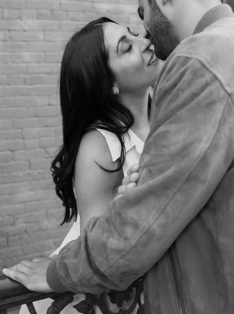 Candid moment of old money engaged couple at a cozy West Village coffee shop in NYC. Discover documentary and timeless New York City engagement photos. 