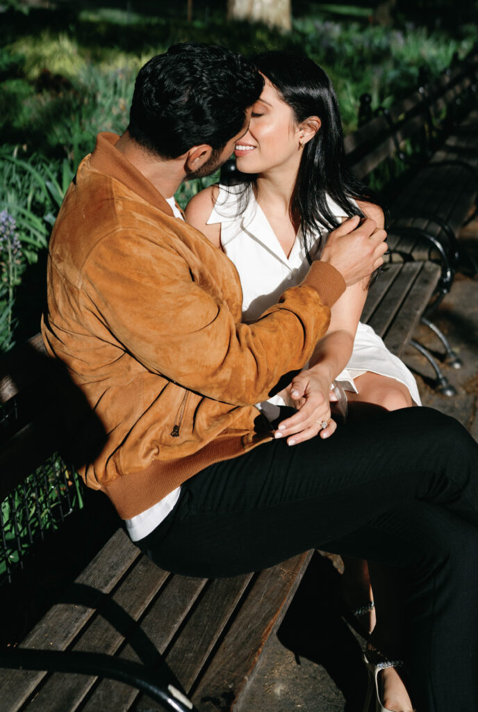 Romantic kiss between engaged couple at Washington Square Park in NYC. Discover intimate and documentary engagement photos in New York City. 