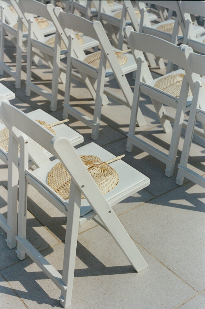 Wedding chairs with fans captured on film. Discover documentary film wedding photography in New York City.