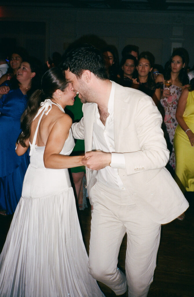 A candid photo of a bride and groom on their wedding day. Discover candid film wedding photography in New York City.