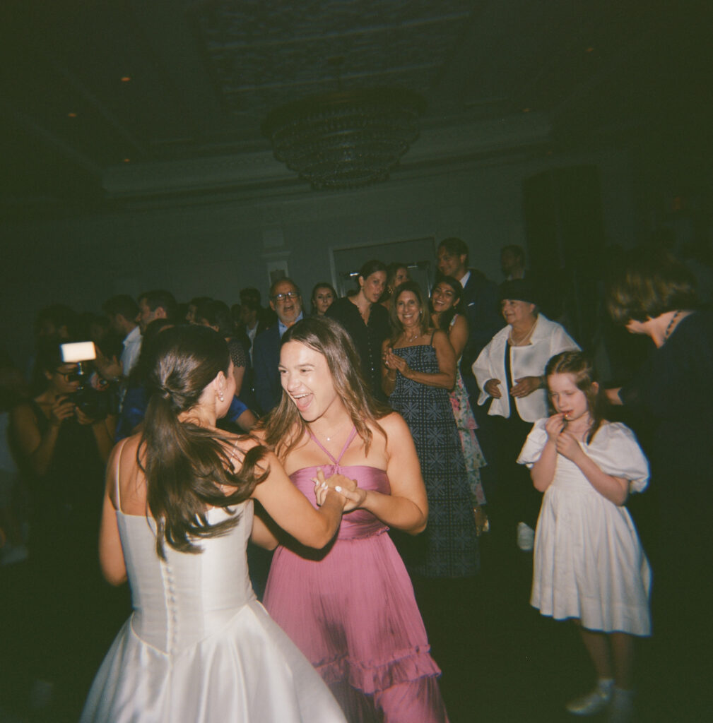 A candid photo of a bride on the dance floor during a wedding reception on 120 film. Discover editorial film wedding photography in New York City.