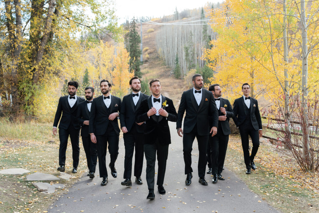 A wedding party poses for fall wedding in Vail. Discover luxury editorial wedding photography in Colorado and beyond.  
