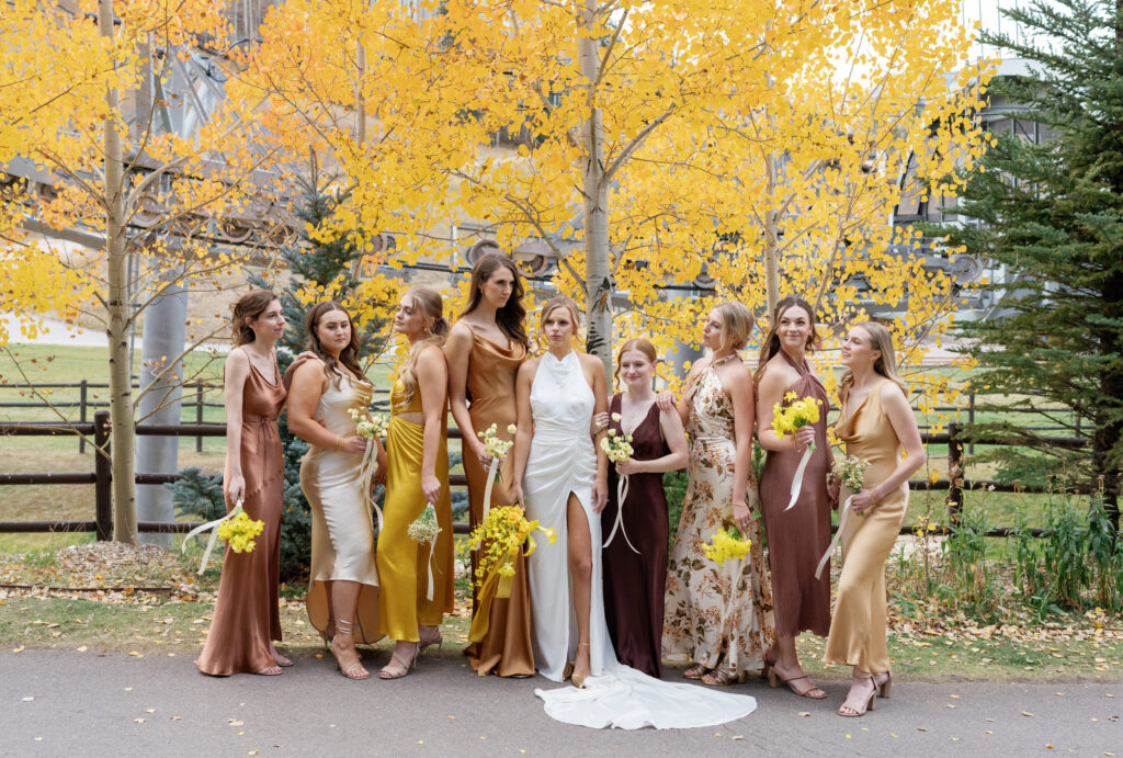 A wedding party poses for fall wedding in Vail. Discover luxury editorial wedding photography in Colorado and beyond.  