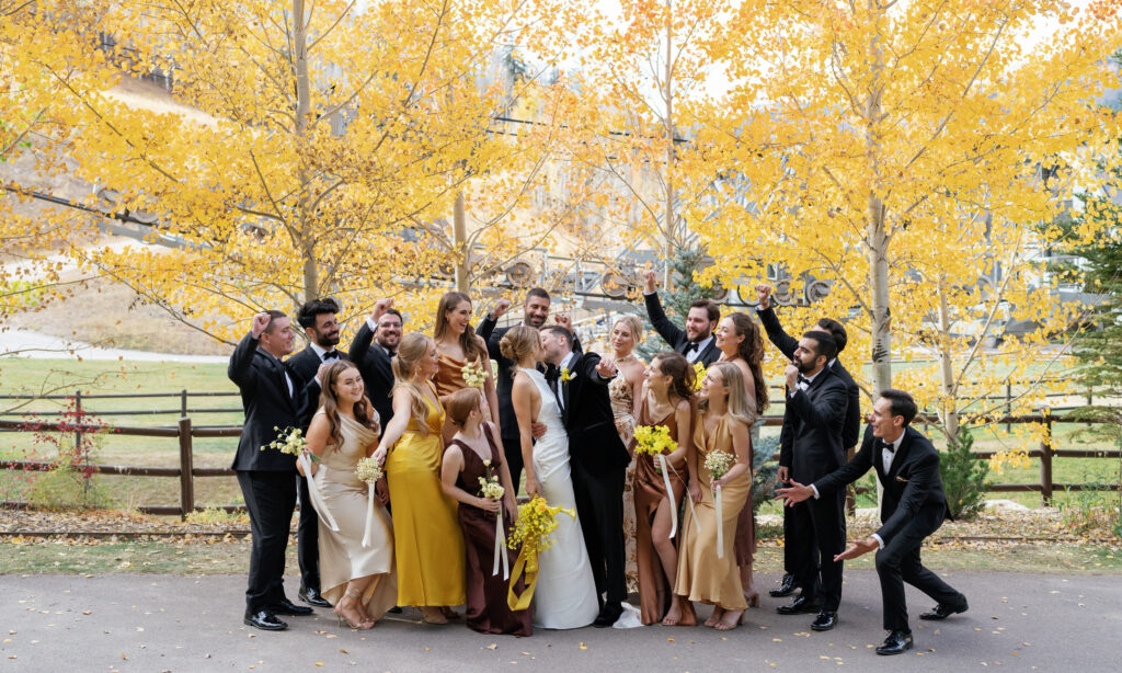A wedding party poses for fall wedding in Vail. Discover luxury editorial wedding photography in Colorado and beyond.  