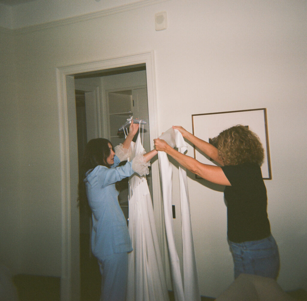 A couple gets ready at Nine Orchard hotel in Manhattan for the New York City Courthouse wedding at City Hall. Discover documentary and editorial wedding photography on film in NYC.