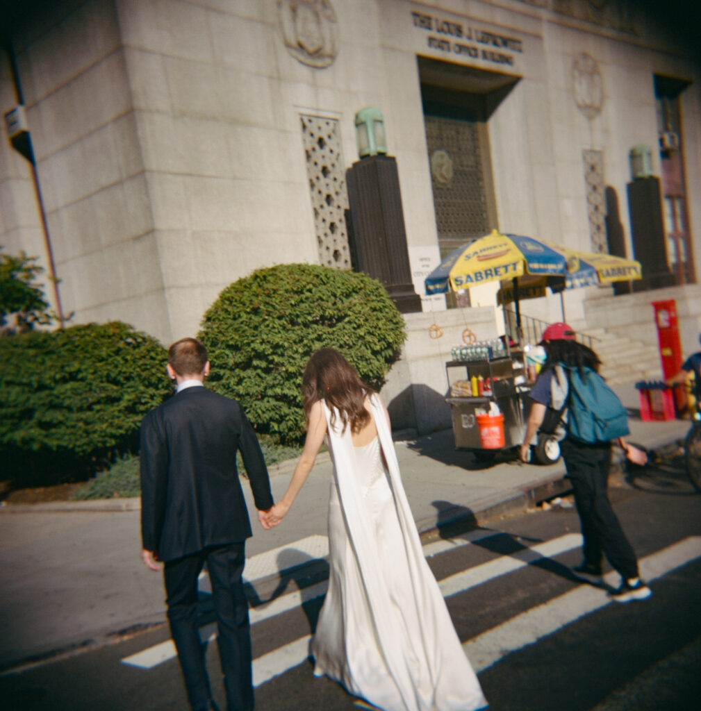 A couple in Manhattan for their New York City courthouse wedding. Discover documentary and editorial elopement and wedding photography in New York City on film.