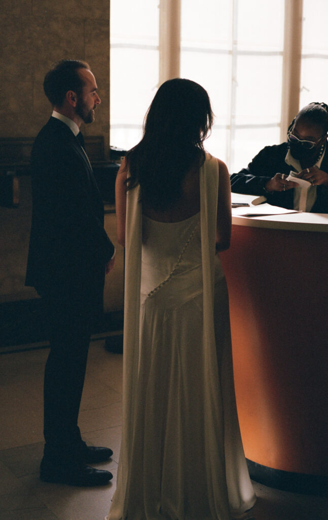 A couple in Manhattan for their New York City courthouse wedding. Discover documentary and editorial elopement and wedding photography in New York City on film.