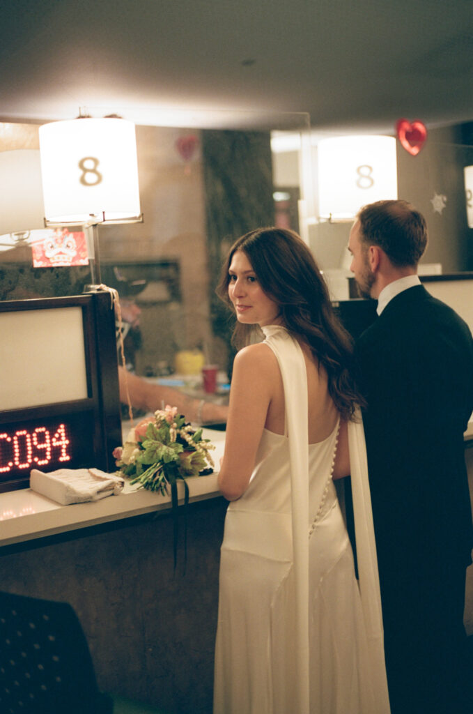 A couple in Manhattan City Hall for their New York City courthouse elopement. Discover a documentary and editorial film wedding photographer in New York City.