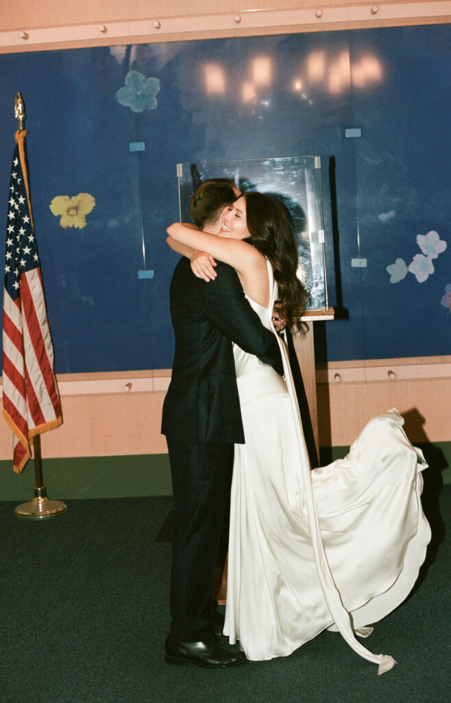 A couple in Manhattan City Hall for their New York City courthouse elopement. Discover a documentary and editorial film wedding photographer in New York City.