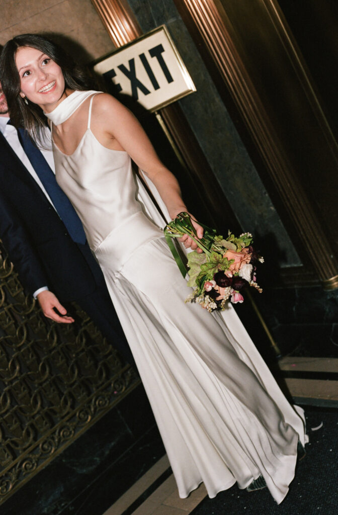A couple in Manhattan City Hall for their New York City courthouse elopement. Discover a documentary and editorial film wedding photographer in New York City.