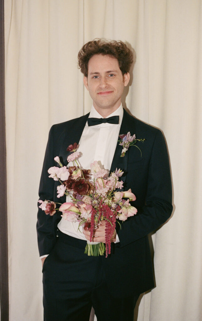 A groom poses for his wedding day in downtown Los Angeles, California. Discover film wedding photography in New York, Colorado, and California. 