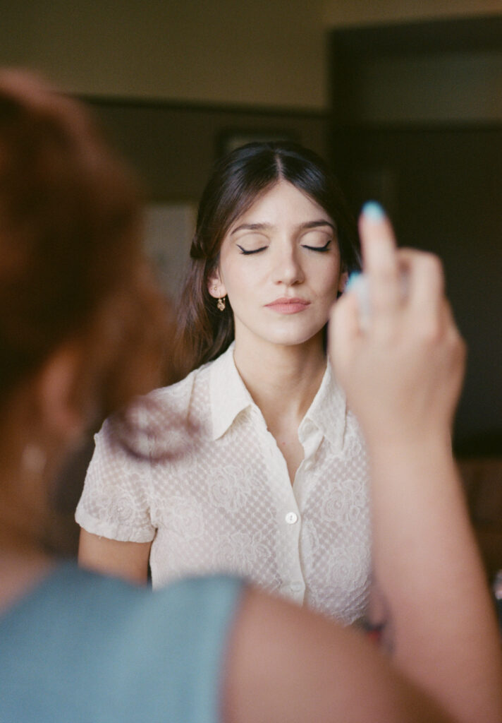 A bride gets ready for her wedding day in downtown Los Angeles, California. Discover film wedding photography in New York, Colorado, and California. 