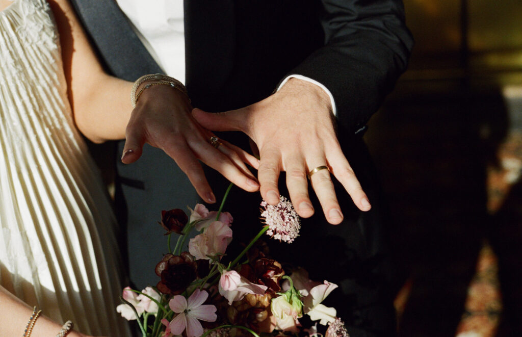 A couple poses on their wedding day in downtown LA. Discover California editorial film wedding photography. 
